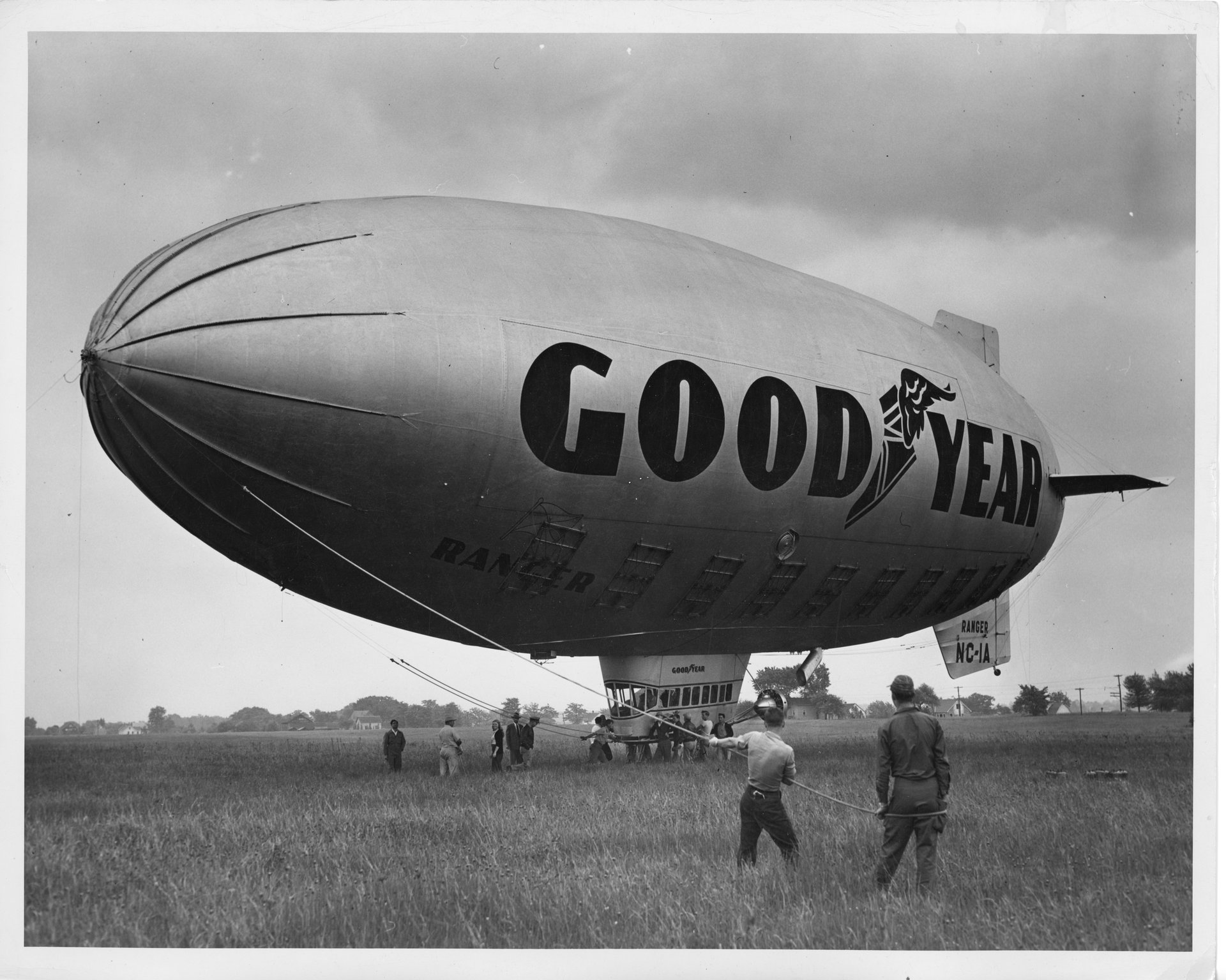 The Goodyear Ranger II (NC-1A) blimp being controlled by a group of unknown people at Buffalo Airpark on June 13, 1947. Tony Riccio and his wife Maxine can be seen under the blimp to the left of the cabin car.