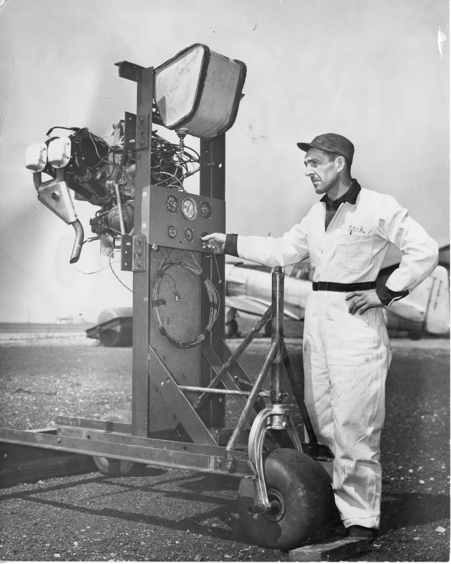 Robert Arnold, the Buffalo Airpark Maintenance Chief, is operating an aircraft engine on a test stand. 