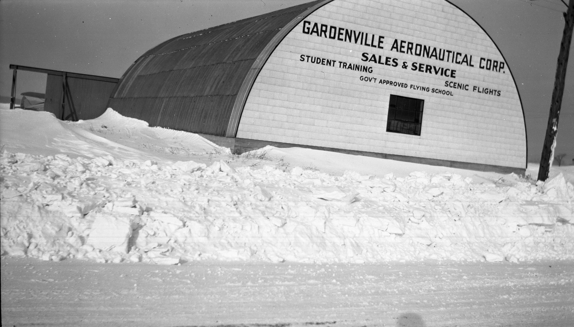 The Quonset hangar at the Garden Airport, aka Gardenville Aeronautical Corp., as viewed from Clinton Street during the winter season.