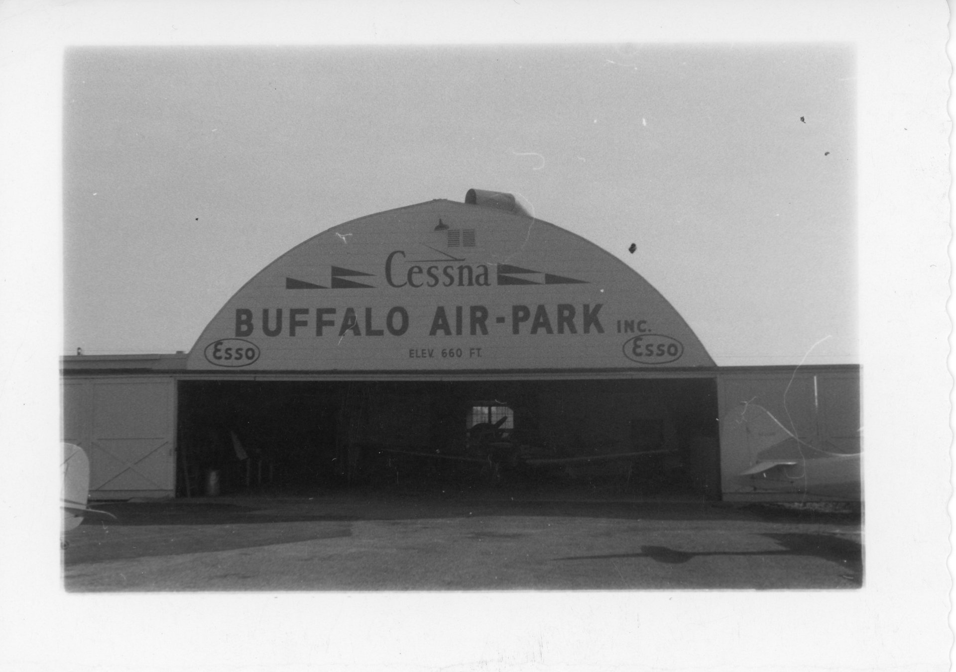 The Quonset hangar at Buffalo Airpark with a newly painted Cessna logo.
