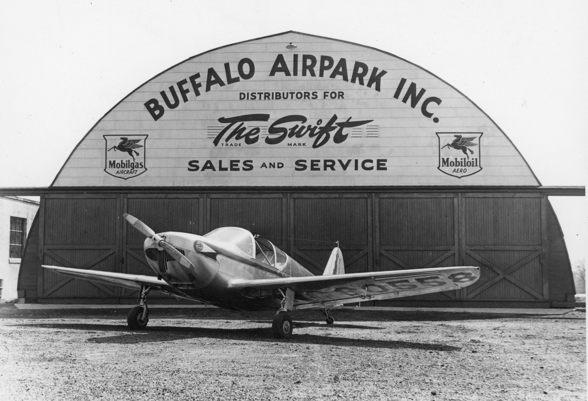 A Globe Swift parked in front of the Quonset hangar at Buffalo Airpark.