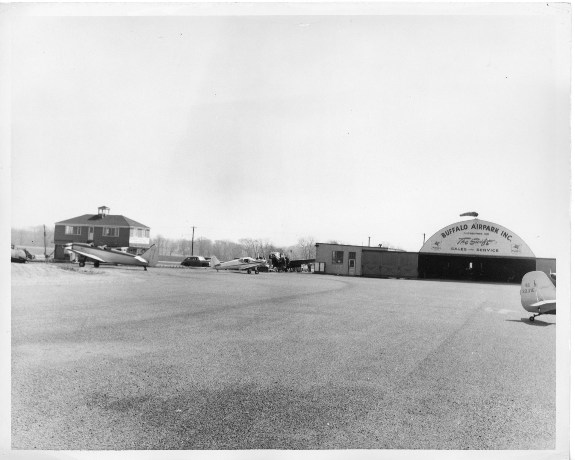 Standing on the tarmac at Buffalo Airpark and looking towards the Quonset hangar and Operations building.
