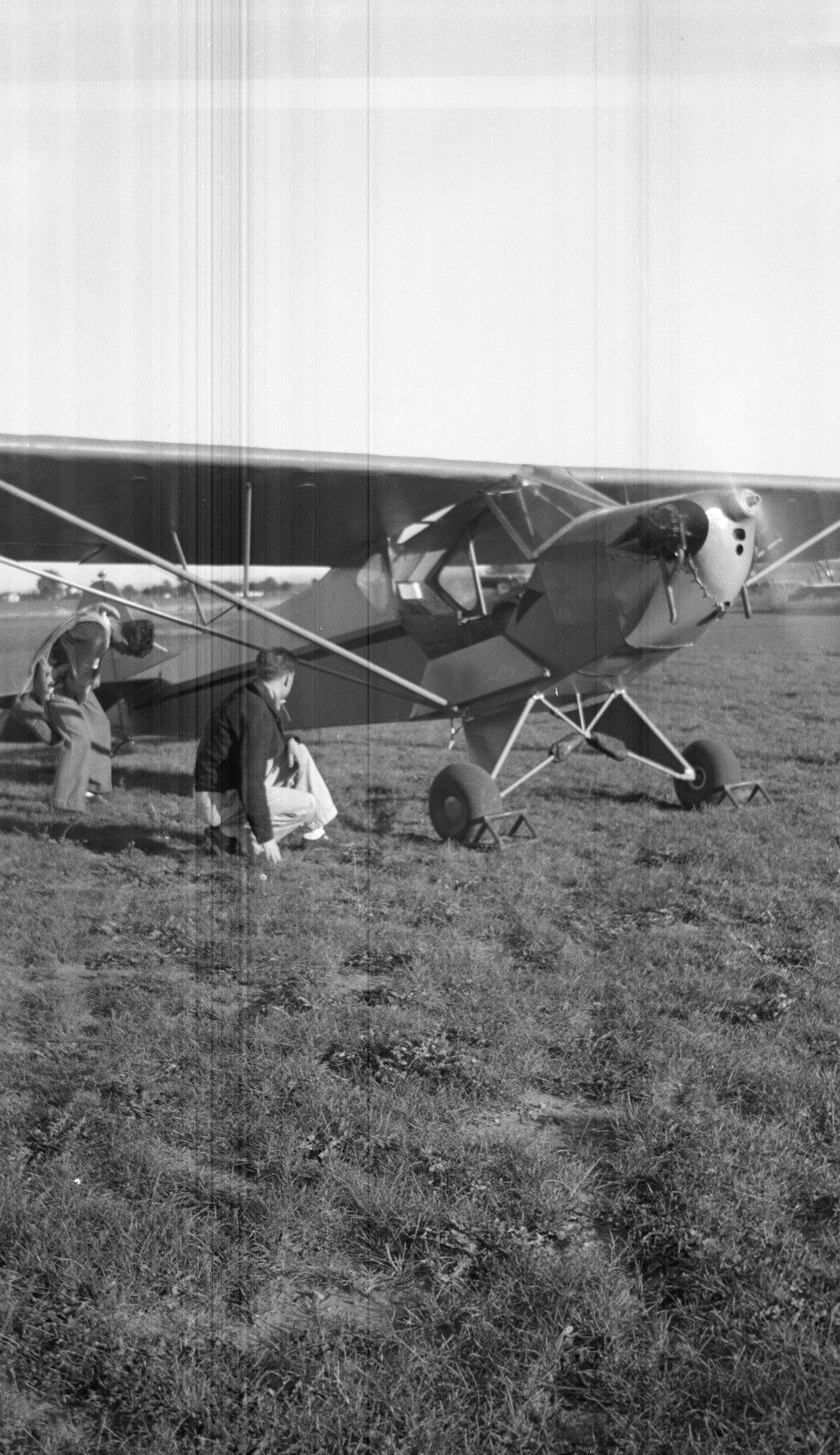 Tony Riccio and an unknown person kneeling next to a running Tayler "Cub" J-2.
