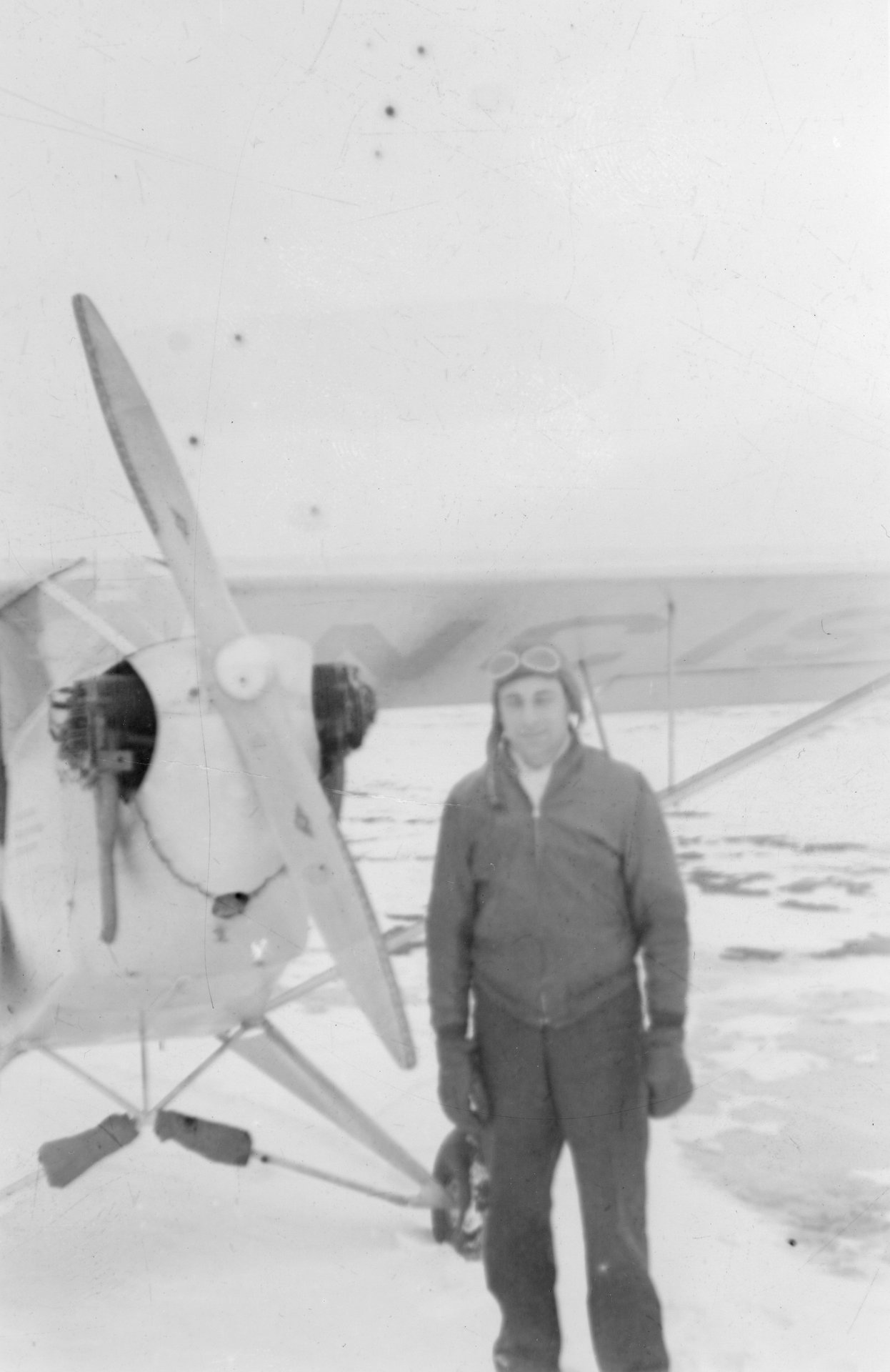 Tony Riccio standing in front of his J-3 "Cub" during the winter season.