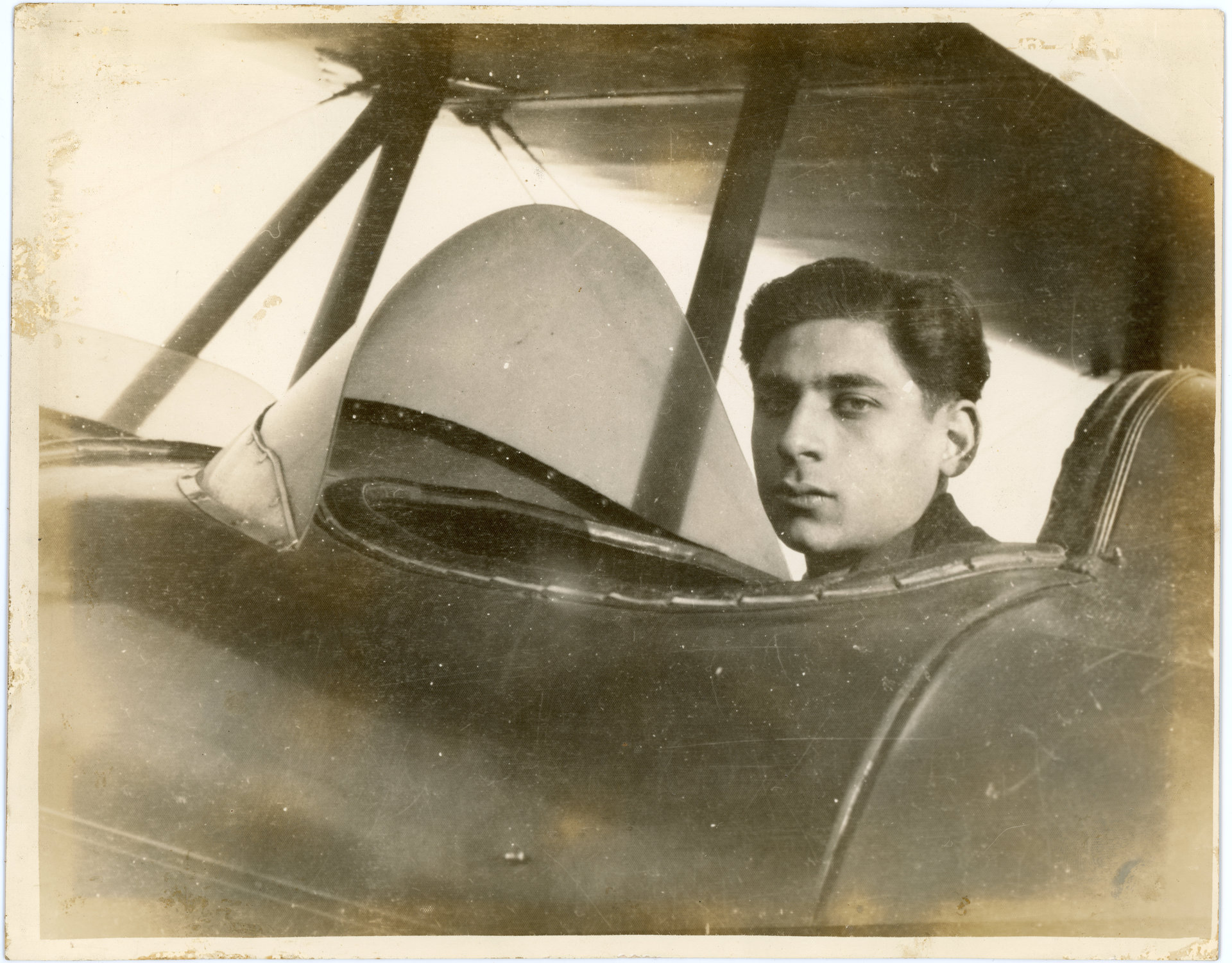 Tony Riccio sitting in the pilot's seat of an Alexander Eaglerock biplane.
