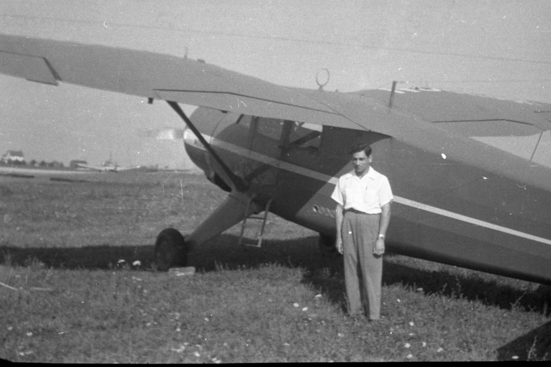 Tony Riccio standing next to a 1946 Stinson Vultee V-77 airplane.