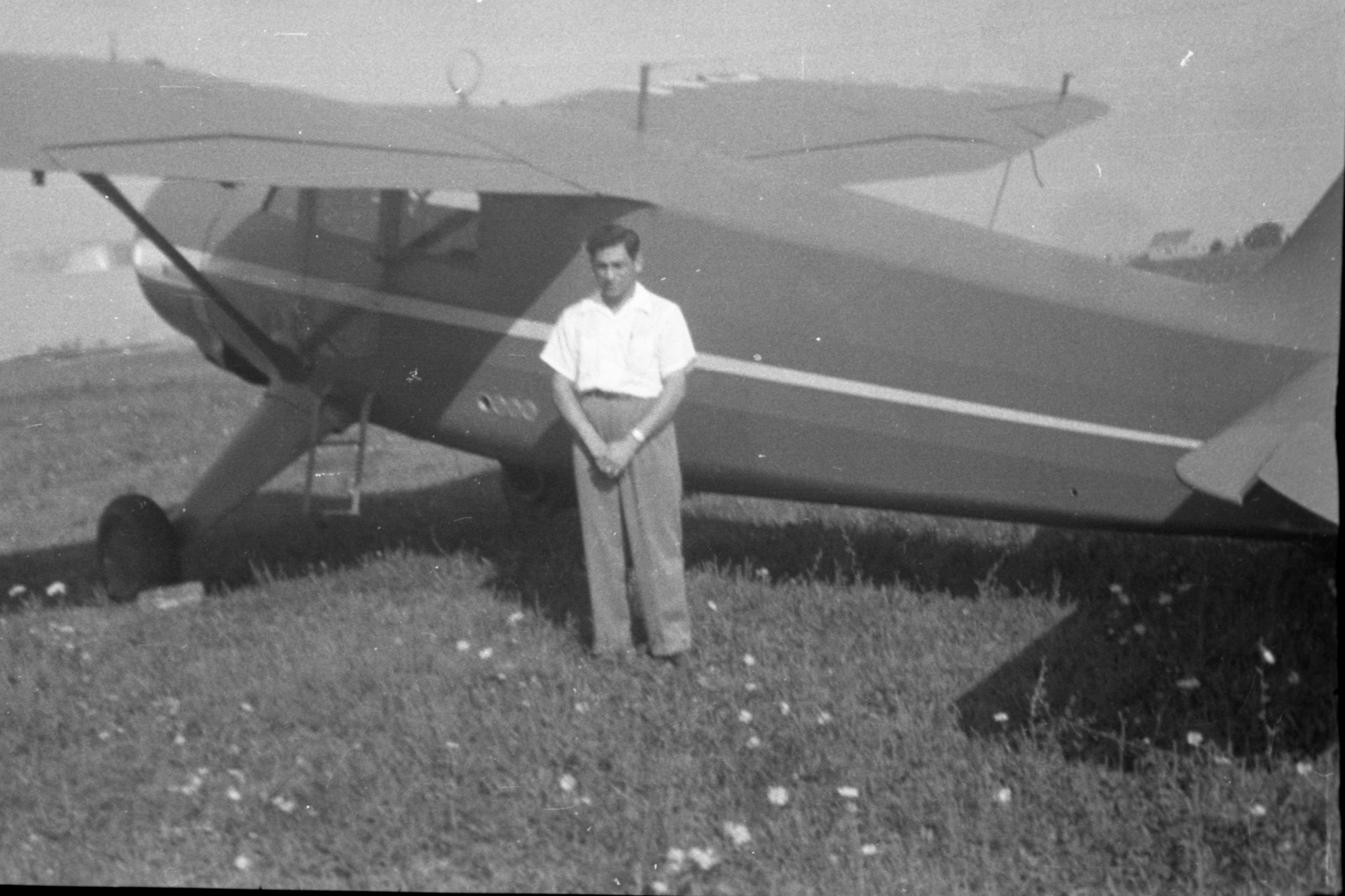 A closeup of Tony Riccio standing next to a 1946 Stinson Vultee V-77 airplane.