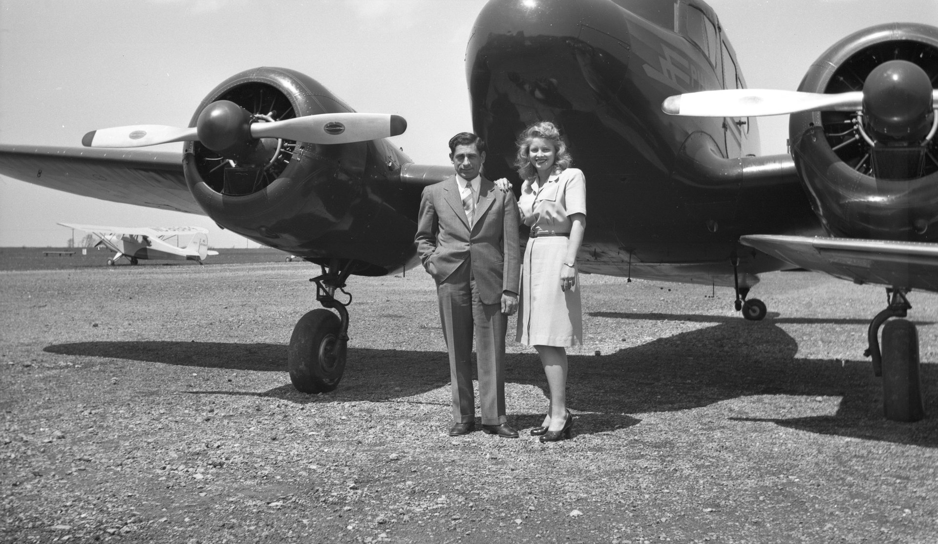 Tony Riccio and his wife Maxine standing in front of a Cessna T-50 twin engine airplane.