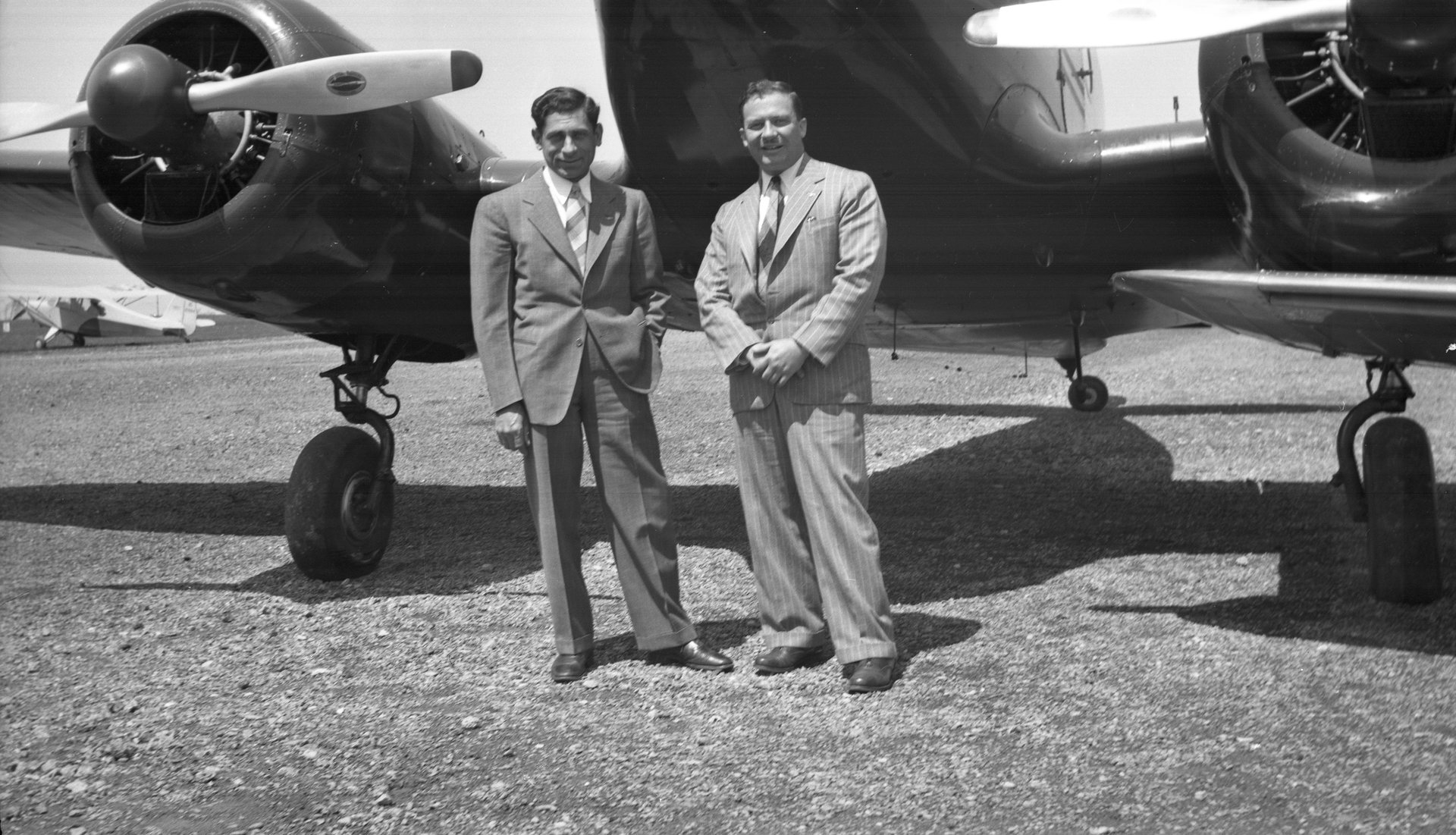 Tony Riccio and an unknown person standing in front of a Cessna T-50.
