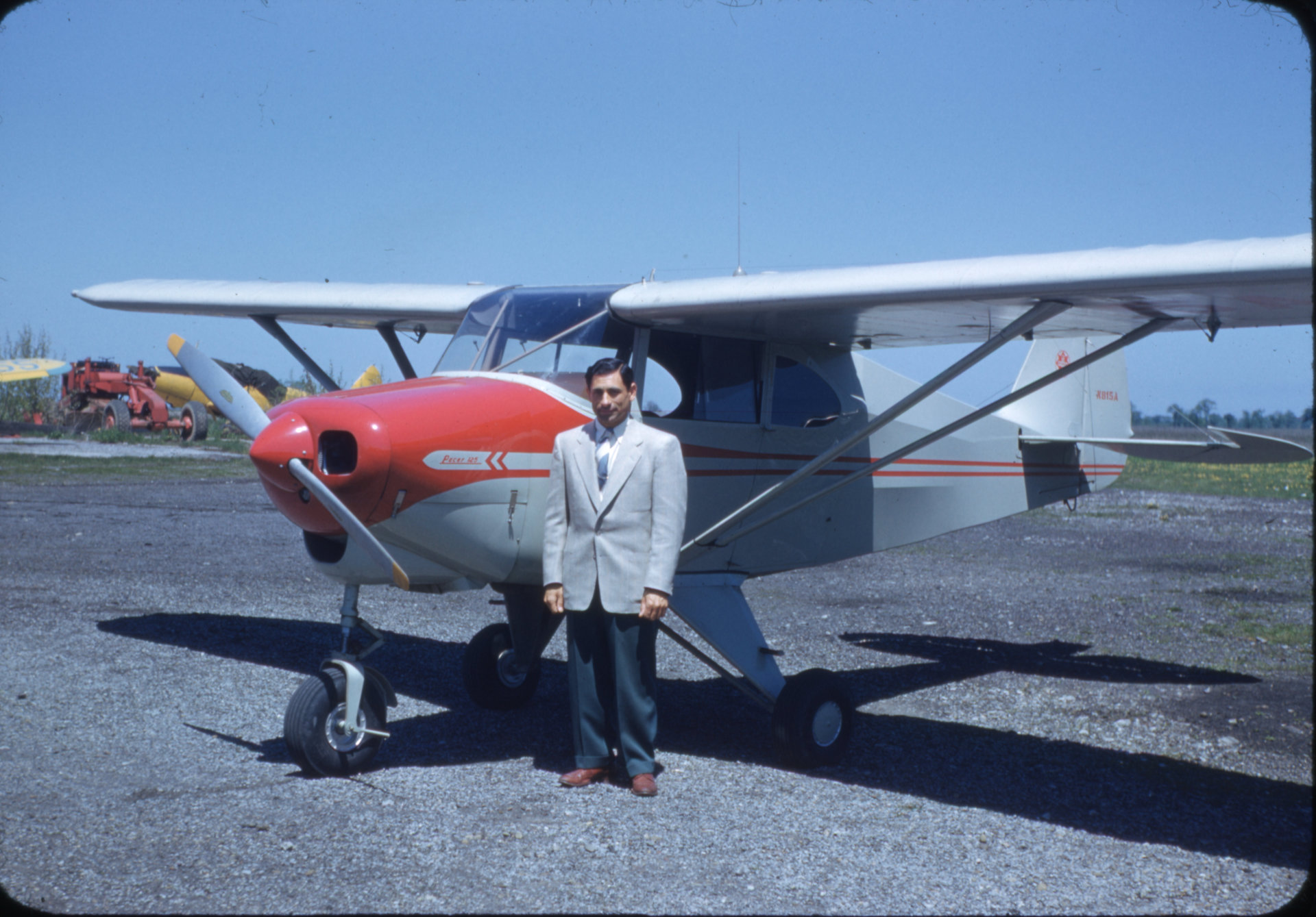 Tony Riccio standing next to a Piper Pacer 125 airplane at Buffalo Airpark.