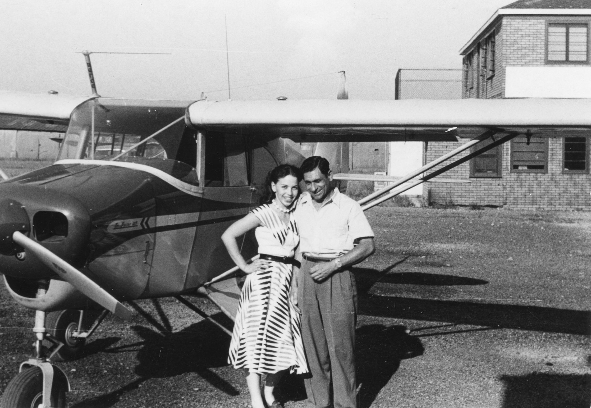 Tony Riccio and an unknown person standing next to a Piper Pacer 125 airplane at Buffalo Airpark.