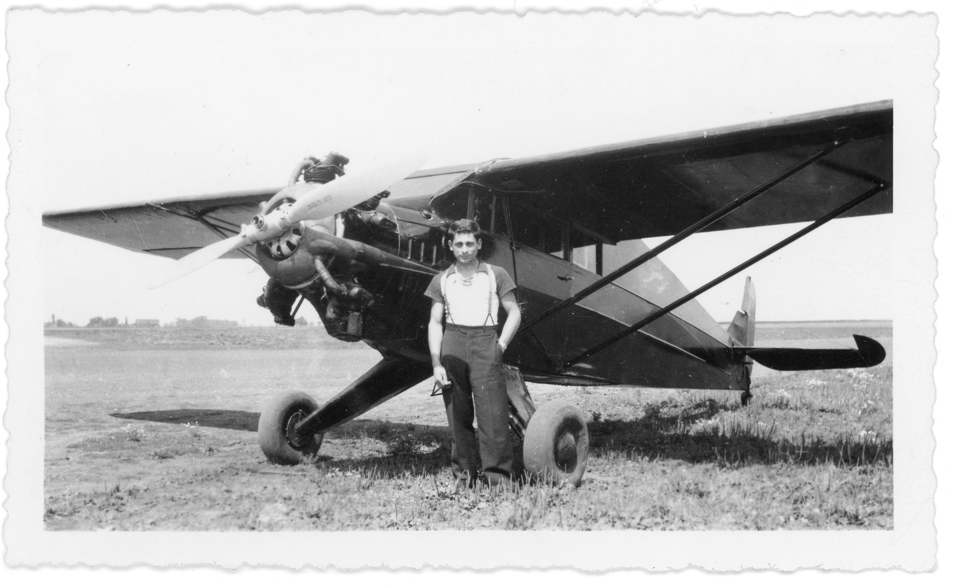 Tony Riccio standing in front of his Aristocrat 102-E airplane.